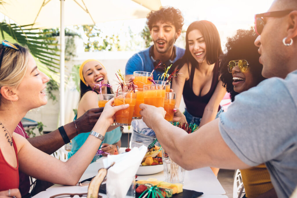 friends cheering to bottomless mimosas brunch in Austin Texas on a sunny day