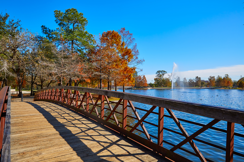 A wooden bridge over the lake at Hermann Park, one of the best places to visit with kids in Houston Texas. 