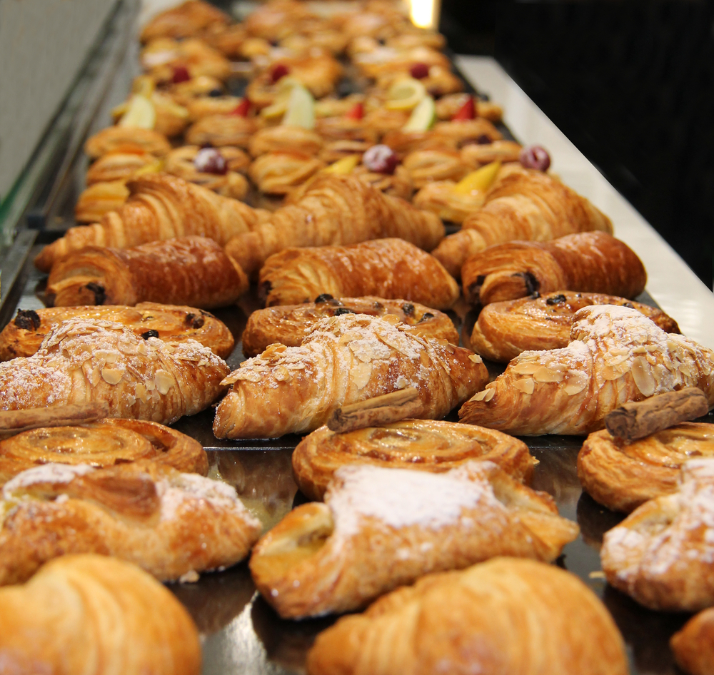 a buffet of pastries including croissants, danishes, and other fruit pastries