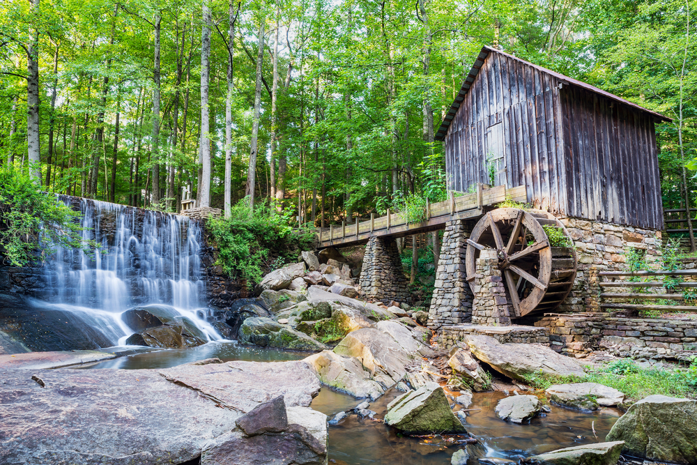 lefler mill, one of the best things to do in marietta sits on the right and a waterfall is on the right 