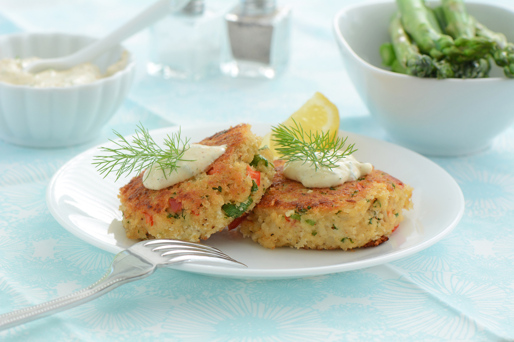 Crab cakes are always a special treat for brunch. These cakes are topped with dill, lemon, and a bit of special sauce.