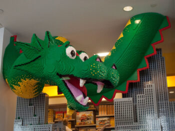 legoland discovery center in dallas with a giant lego dragon coming down from the ceiling