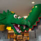 legoland discovery center in dallas with a giant lego dragon coming down from the ceiling