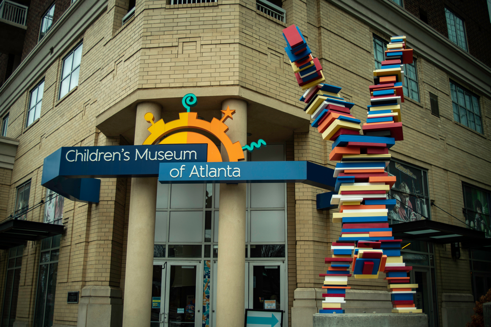 Children's Museum of Atlanta exterior with a bright sign and a sculpture 
