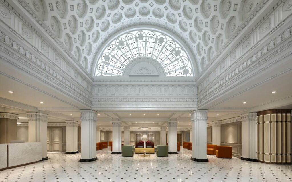 Classy lobby at Hamilton Hotel with high, arched ceilings and pillars all in white.