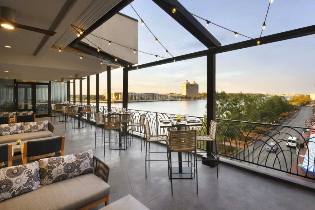 Terrace with view of the street and river from Hyatt Regency Savannah where to stay Savannah.