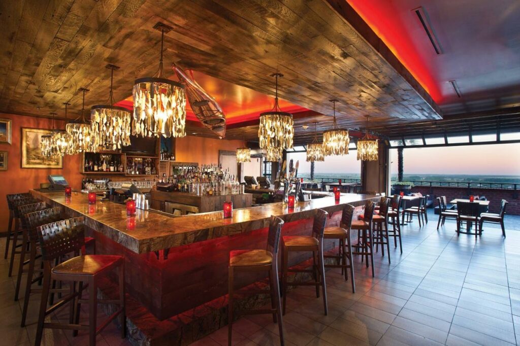 Elegant bar with chandeliers and views of the city.