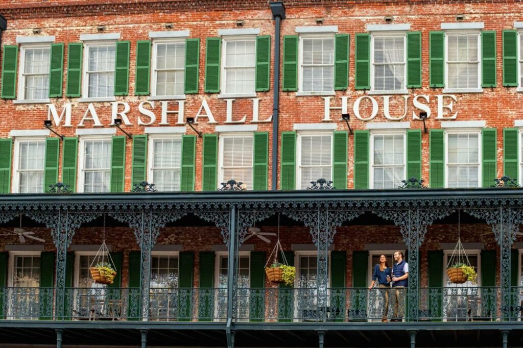 The historic brick and iron exterior of the Marshall House, where to stay in Savannah, GA.