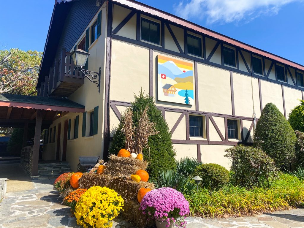 little Switzerland in the blue ridge mountains is one of the best towns to visit. here is an old school building like in Europe with fall flowers. 