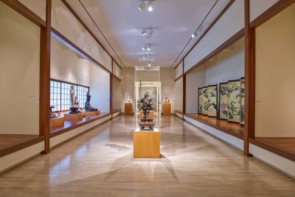 The inside of the Dallas Museum of Art shows a long hallway of light up exhibits. This museum is open until midnight some nights, so definitely explore some of the best things to do in Dallas at night!