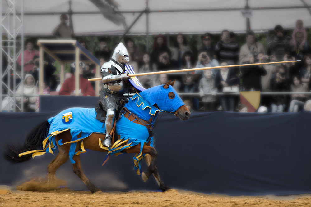 At Medieval times, which is one of the best things to do in Dallas at night with a family, knights (as seen in this photo) duel against one another. This night is jousting in armor, and is decorated on a blue horse. 