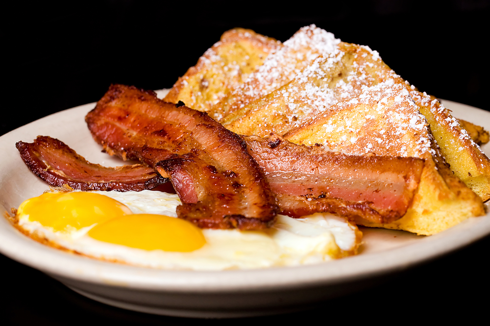 a good old fashion diner food plate with eggs, bacon, and French toast. 