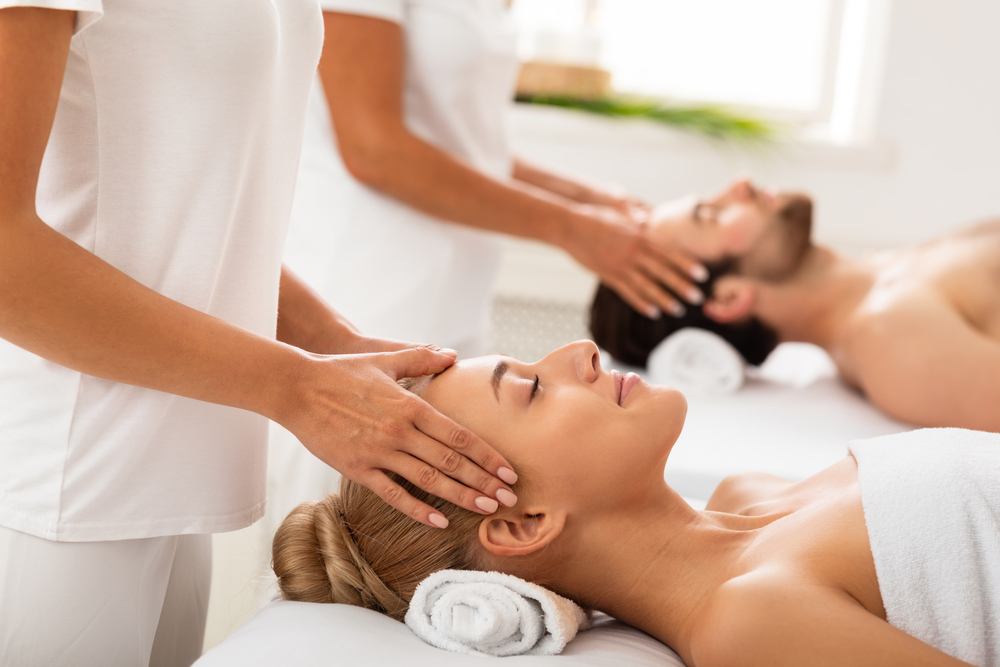 a couple getting a massage in the Ritz Carlton. 