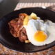 steak and eggs on a black plate at one of the best brunch restaurants in Charleston SC
