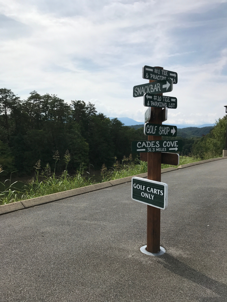 A wooden sign gives directions to different parts of Gatlinburg Golf Course, one of the best golf courses in Tennessee that's open to the public.