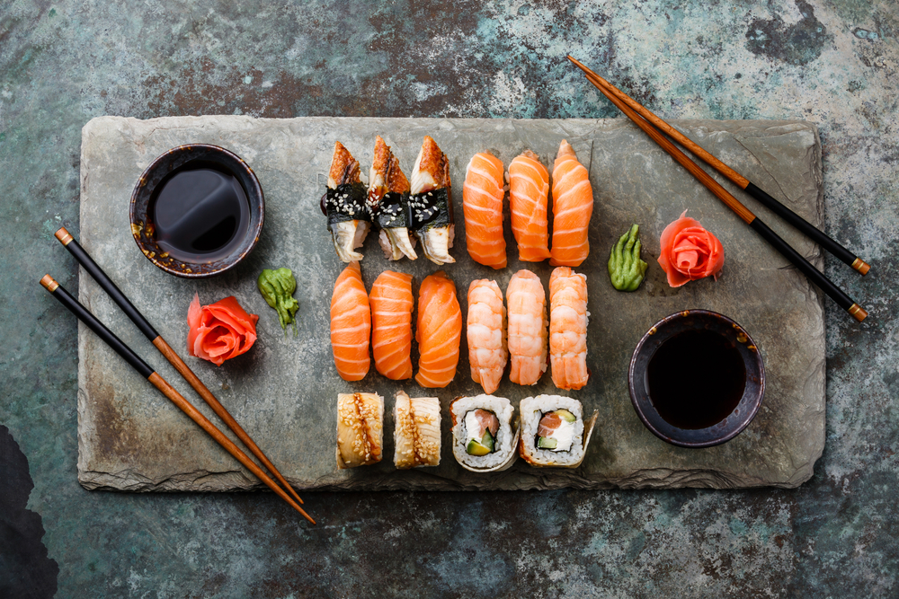 Beautiful slate slab of gorgeously arranged sushi, soy sauce and chopsticks, a feature at one of the best restaurants in Annapolis!