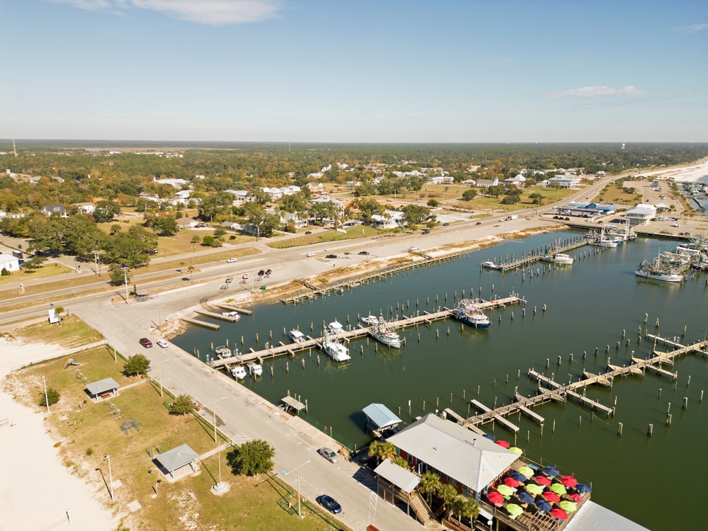 marina photo from above looking down at roads, boats docked in the marina, and a restaurant that is one of the best things to do in pass christian