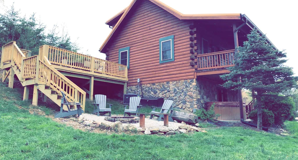 cabins with hot tubs in Kentucky features outdoor fire pit second story deck and covered hot tub