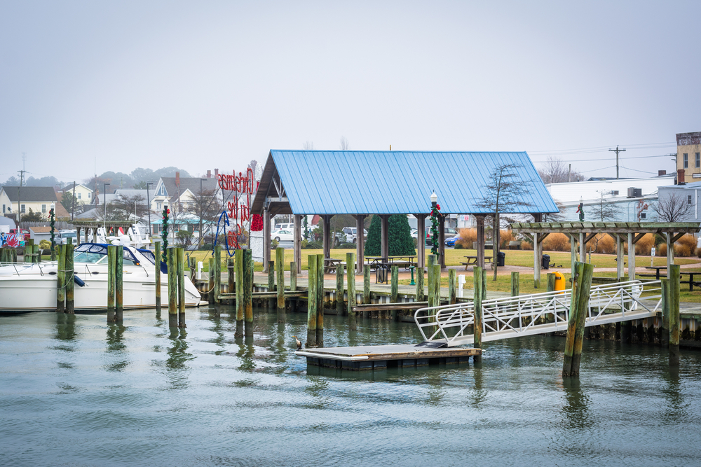 View of the Chincoteague Bay Waterfront, in Chincoteague Island, Virginia. The picture shows the dock area with the town in the background.   