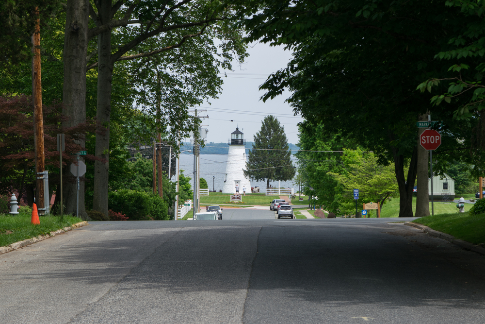 view down a  road of Havre De Grace showing the lighthouse and bay in the distance
