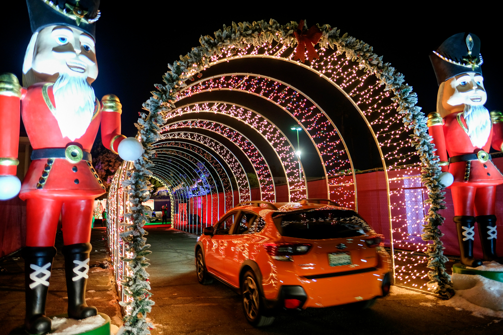 an orange car driving through a light display in Maryland. This is so much fun to explore with your family 