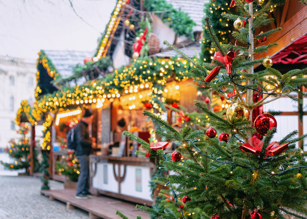 a photo of the christmas markets in Baltimore with a stand and a man ordering a drink 