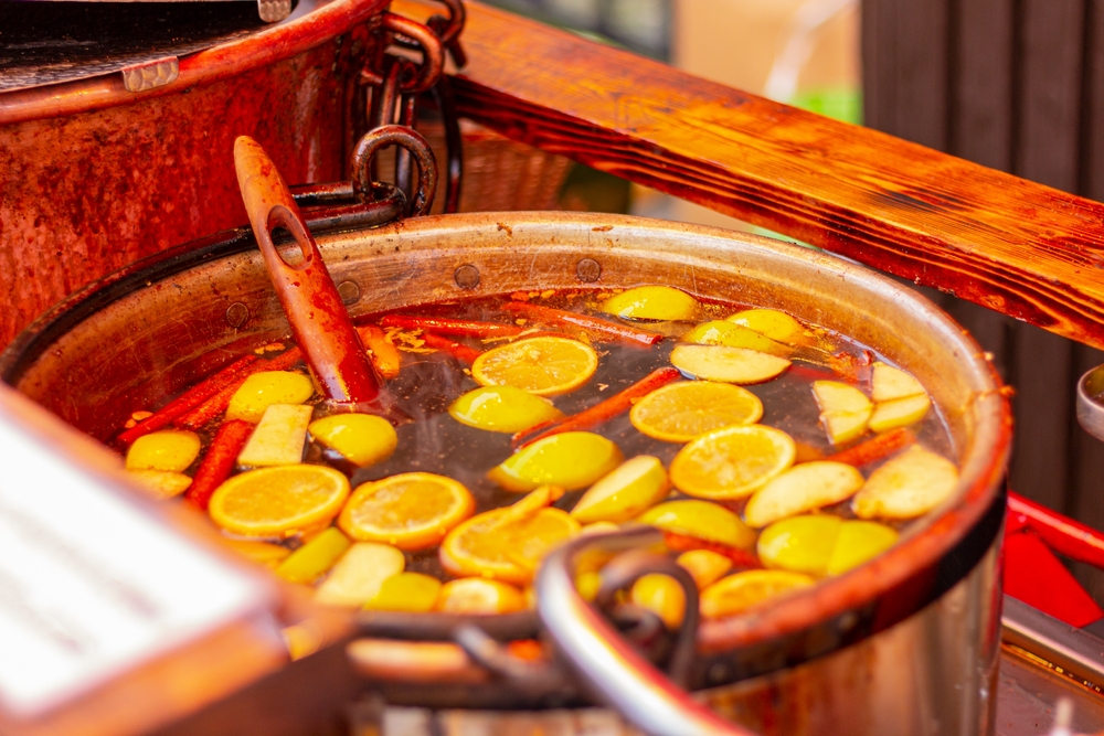 a large container of gluhwein sits outside at a christmas festival in new orleans 