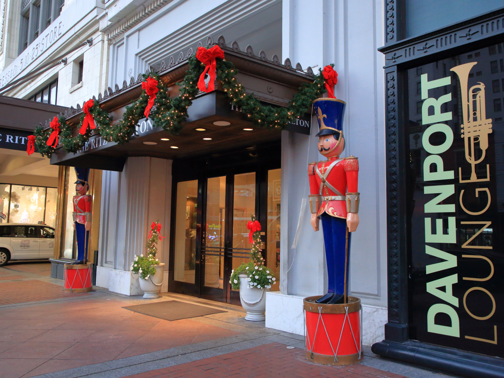photo shows the outside of the ritz carlton in new orleans with christmas decorations out front including two large nut crackers beside the doors 