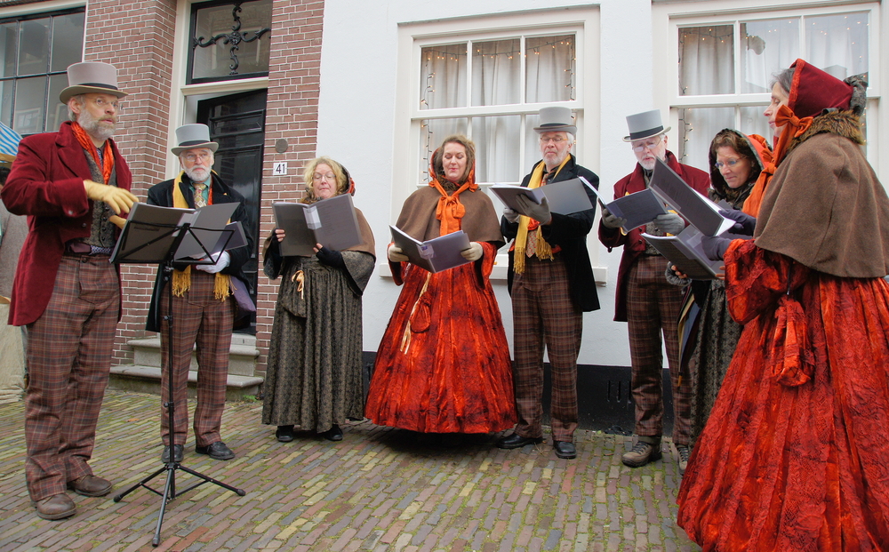 A group of carolers stand around old Franklin street, taking us back in time to Dickens' period. This is the perfect way to celebrate the old ways we once did the holidays, even if today we are in Christmas in Nashville. 