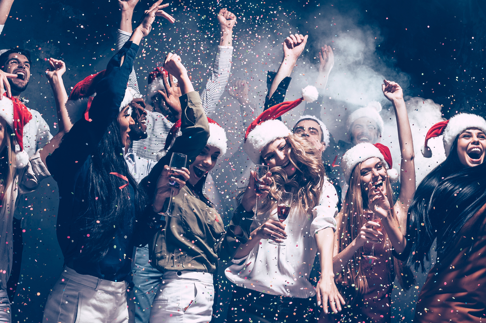 A bunch of people party, drink, and celebrate the holiday in Santa hats at the Santa pub, one of the coolest things to do in Nashville for Christmas.