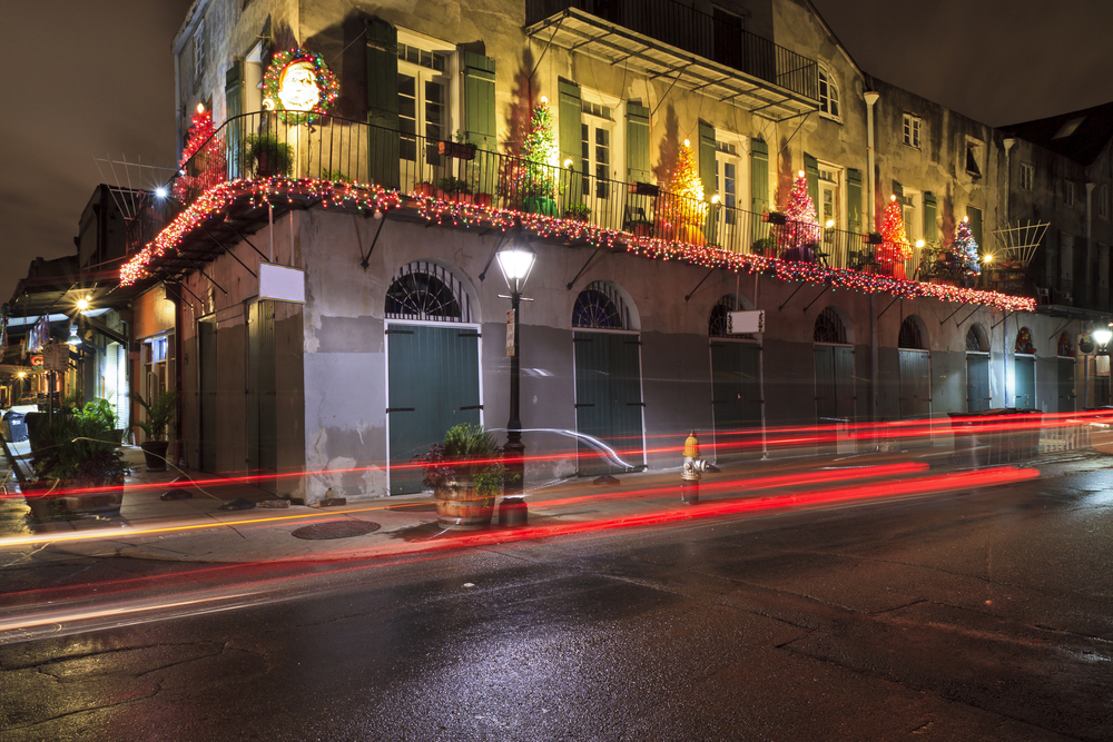 a photo of a street decorates with trees and lights for christmas in new orleans, picture taken at night time