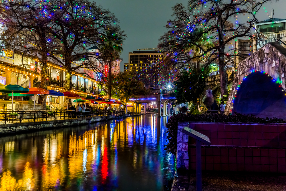 Christmas Lights reflecting off of the water in the beautiful city of San Antonio, one of the best Christmas towns in Texas