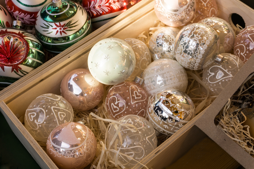 boxes of ornaments, some white and gold, some green and red, that you might find while shopping for Christmas collectibles in Charleston 