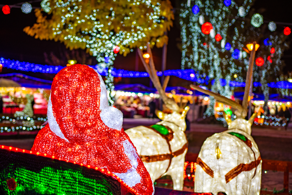 light up Santa and reindeer decorations surrounded by other Christmas light installations in the background, what you might see spending Christmas in Charleston 