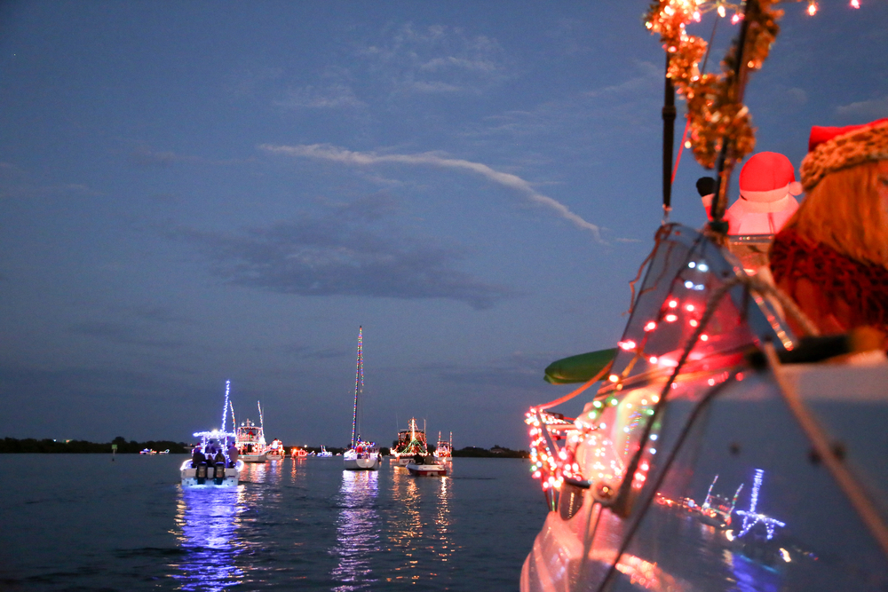 boats floating down the river, decorated in Christmas lights and blow up Santas. Something you might find at the Holiday Boat Parade