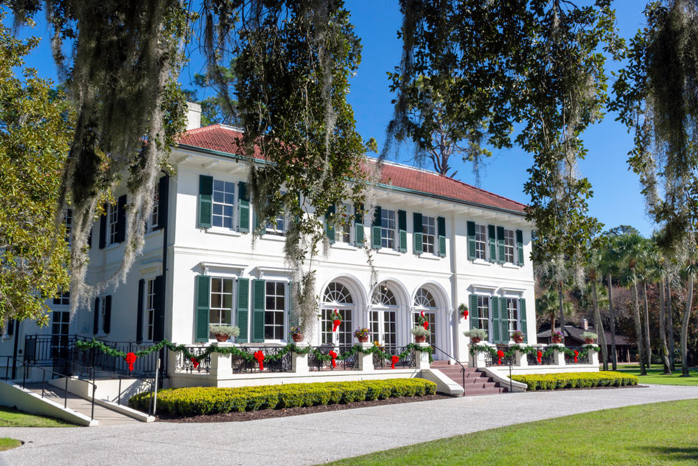 A house on Millionaire's Row is decorated with garlands and bows on Jekyll Island, one of the best Christmas towns in Georgia.