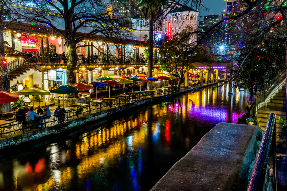 Christmas Lights reflecting off of the water in the beautiful city of San Antonio, one of the best Christmas towns in Texas