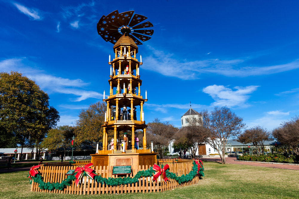 the centre of Fredericksburg is decorated with German Christmas traditional settings - including this wooden tower with figurines and wreath trimming wrapped around it!