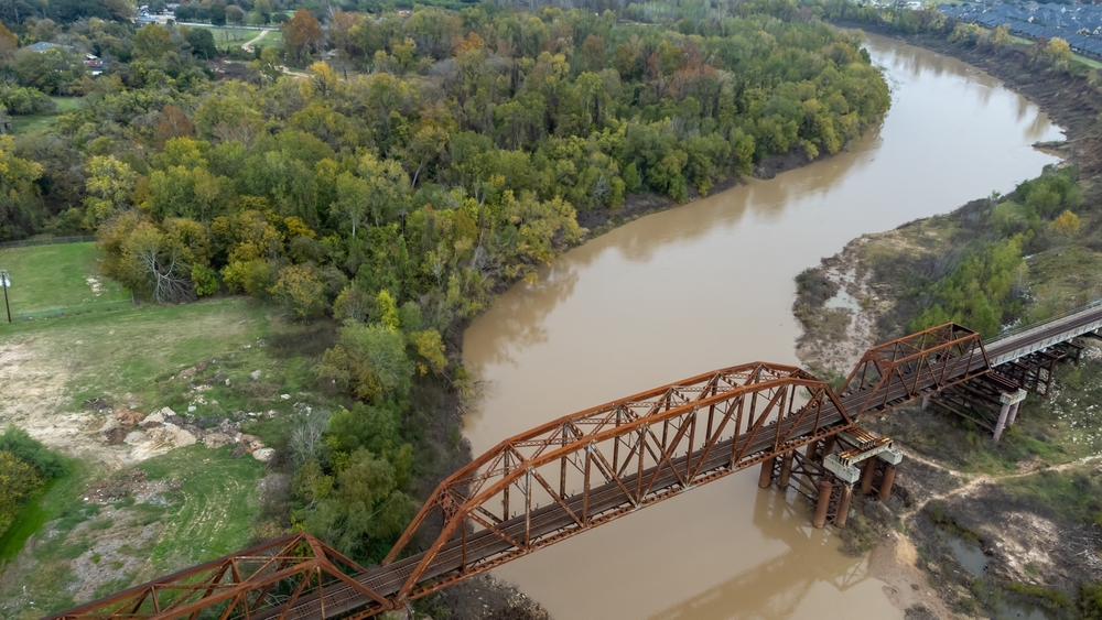 An aerial image of the river that runs through Richmond, TX, one of the highlights of visiting the city and enjoying the natural beauty of the landscape!