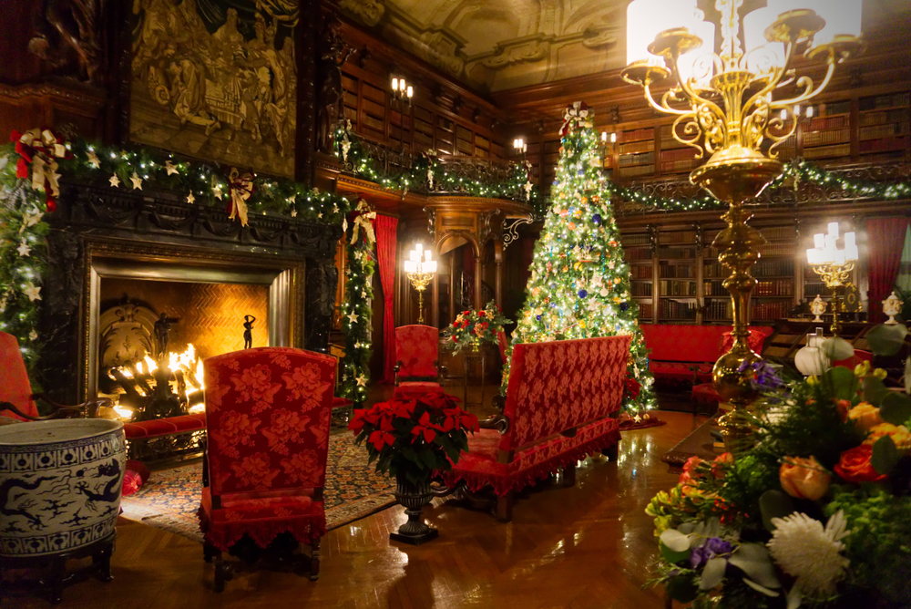 asheville, one of the best christmas towns in north carolina, photo shows a fire place and seating surrounded by christmas decorations