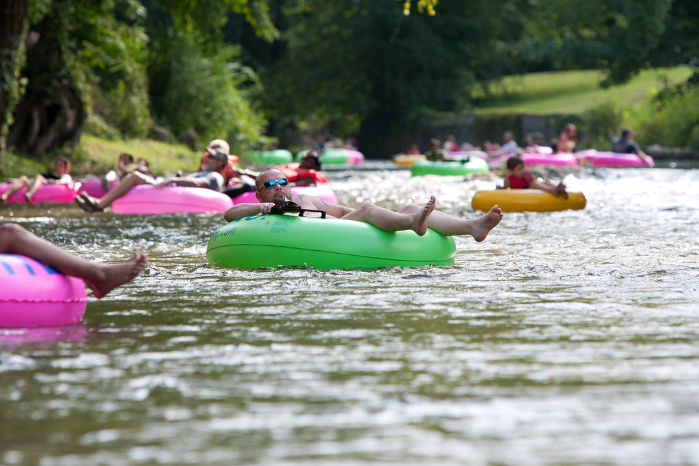colourful tubes filled with people enjoying the atmosphere and beautiful scenery, enjoying an afternoon on the natural lazy rivers in North Carolina