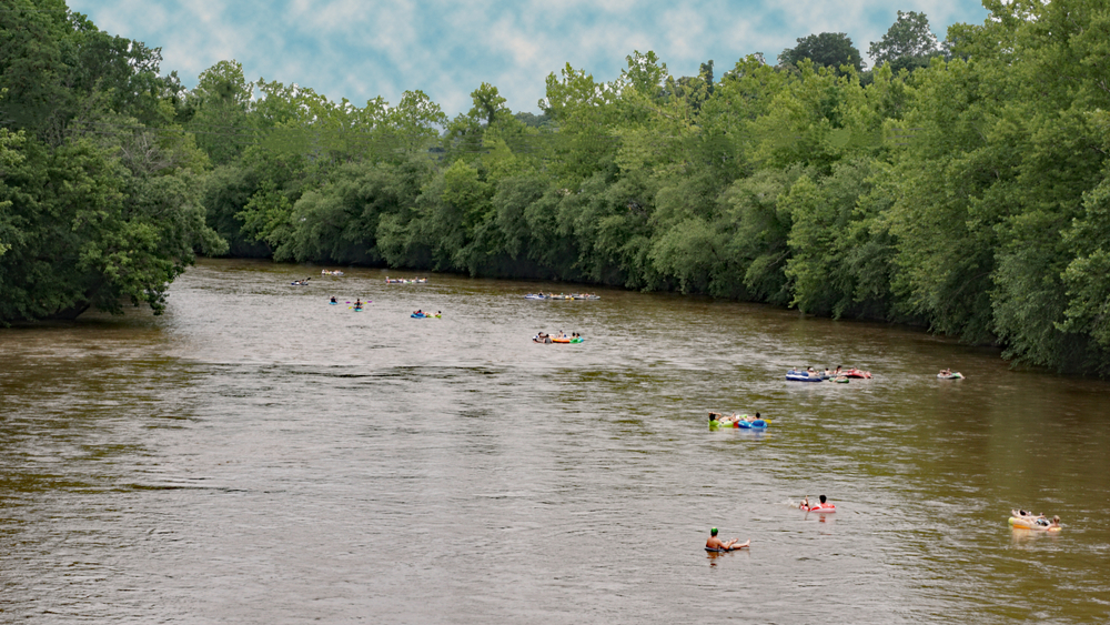 a group of people floating on their tubes down the longest tube trail in North Carolina!