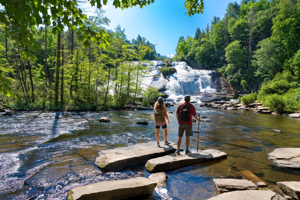 two people standing out looking at a waterfall in North Carolina. 