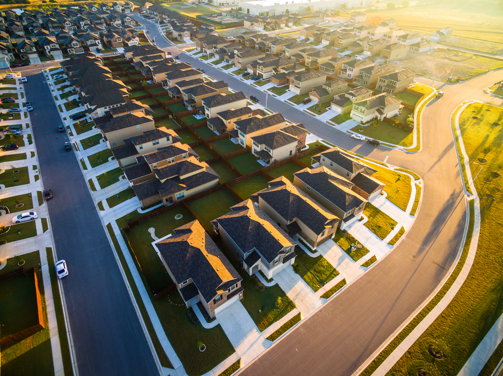 Morning sun hits the perfectly laid out houses of an Austin suburb, where people are living in Texas.