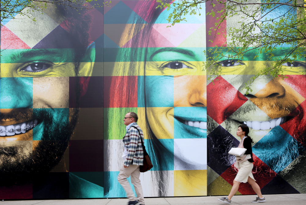 A mural in Austin, TX depicting smiling faces of different races and genders, as part of the South by Southwest Annual music, film, and interactive conference and festival.