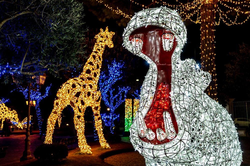 A hippo and giraffe made out of Christmas lights at the Riverbanks Zoo and Gardens in Columbia, one of the best Christmas towns in SC.