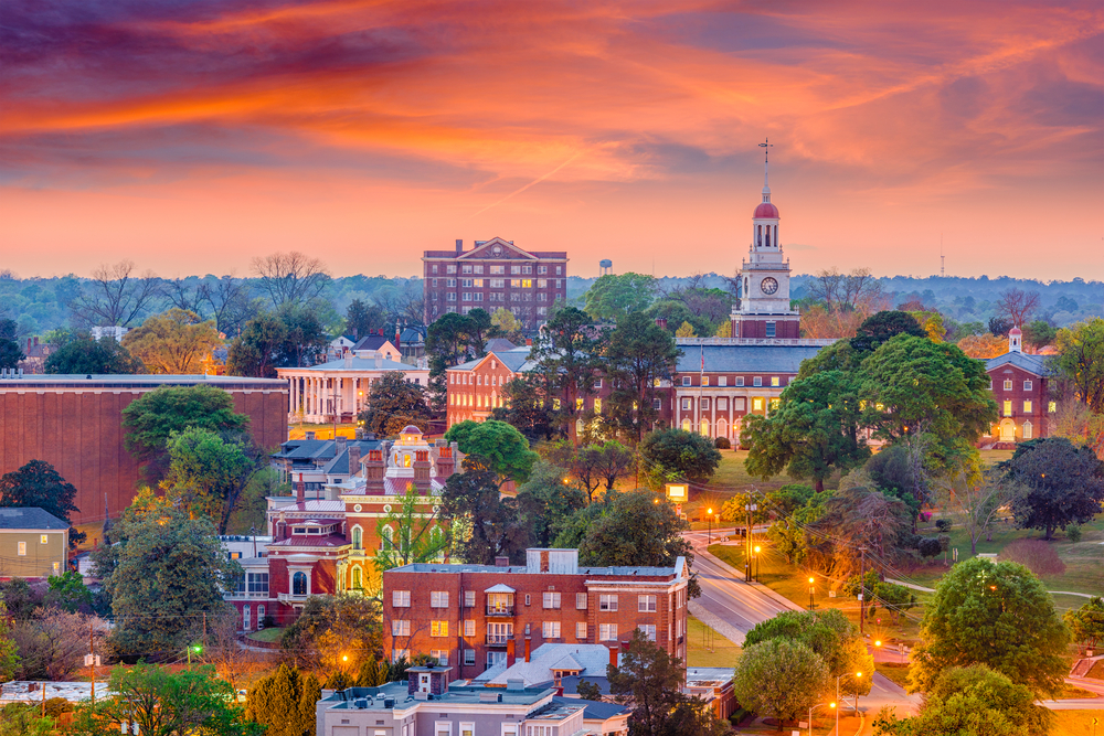 one of the best places for living in Georgia, Macon. photo of the city early in the morning with lights on the buildings and along the street 