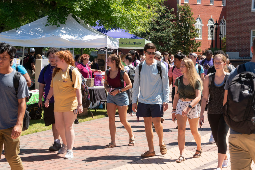 A group of people milling around at a community event. 