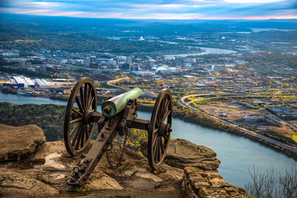 the cannoning sitting on top of the lookout mountain hill looking over the beautiful town at sunset 