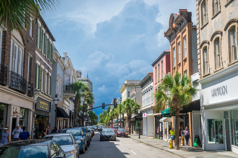 Car driving down King Street with pretty shops in Charleston.